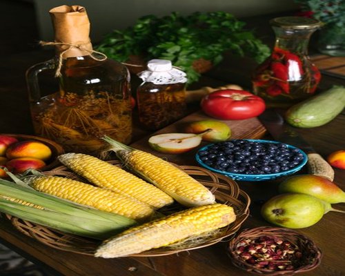 Fresh vegetables and fruits on a wooden table in a Polish kitchen